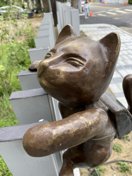 半夢半醒的貓咪攀牆上學(xué)，摹寫著孩童們匆忙上學(xué)的日常，藝術(shù)家─曾永玲發(fā)揮天馬行空的想像投設(shè)其中。