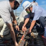 新業(yè)建設(shè)名譽董事長穆椿松先生（圖前排右一），於樓頂安裝「噴金漆鋼筋」即為上樑，古有云「上樑有如人之加冠」，不論在建築進度及民俗學上都極具意義。